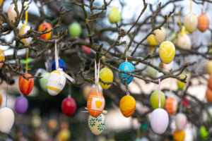 Tree decorated with colorful Easter eggs, street Easter decor.